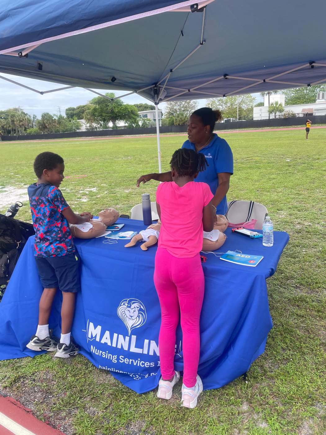 Kids learning CPR hands-on at a community event