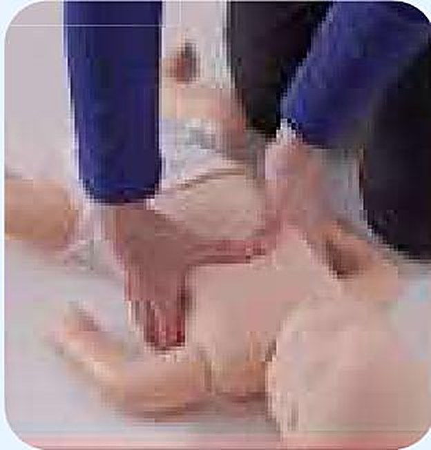 Practicing infant CPR compressions on an infant manikin